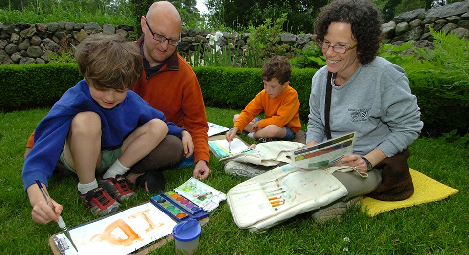 A family enjoys painting in the park