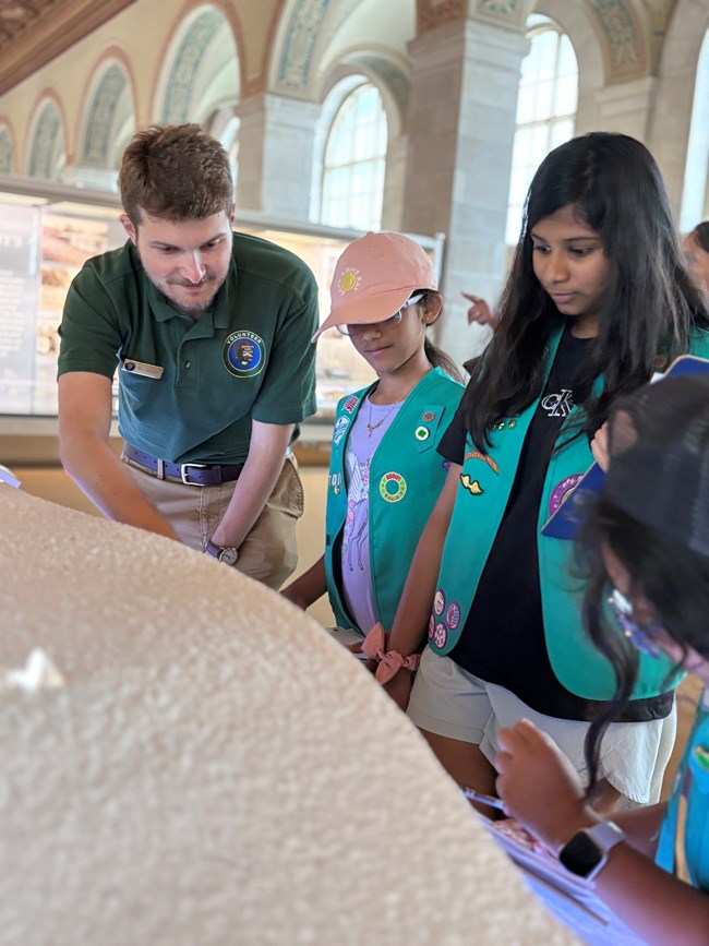 Education Volunteer helping Girl Scouts with learning about the White House inside the White House Visitor Center