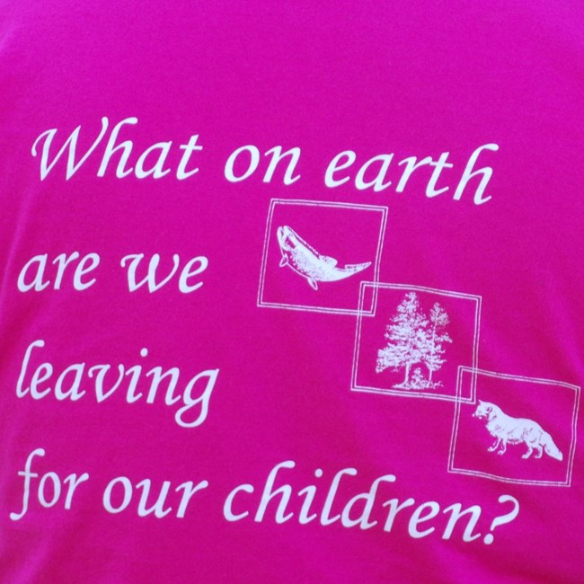 Close-up view of back pf Whiskeytown Environmental School t-shirt stating "What on earth are we leaving for our children?"