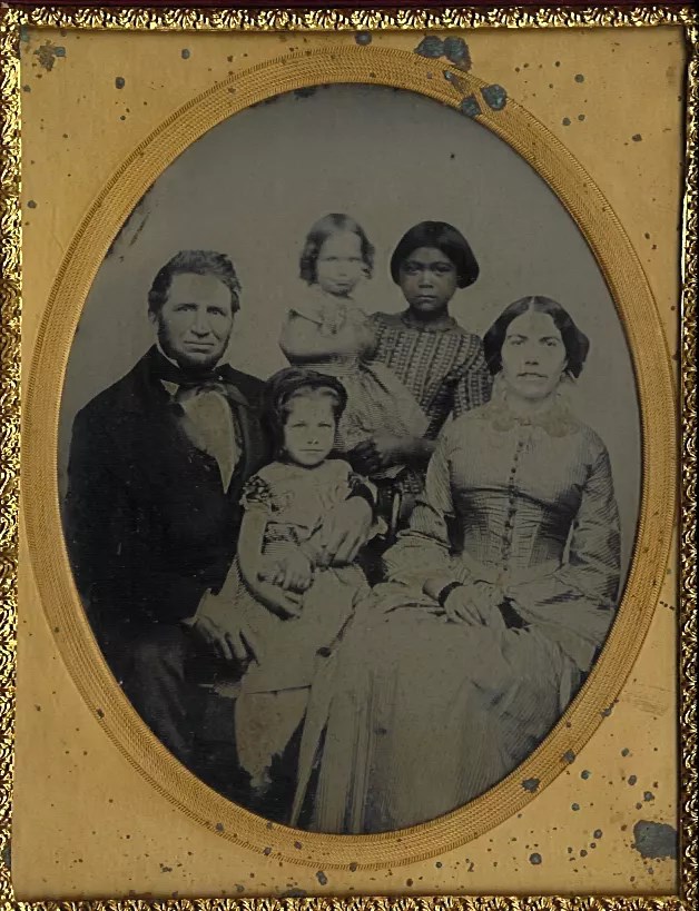 Historic 1850s photo of Camden family. Kate, with darker hair, is holding the baby. Kate was a Native American servant to the family during this time.