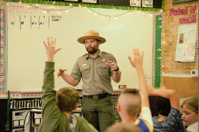 Interpretive park ranger giving a program for a fourth-grade classroom.
