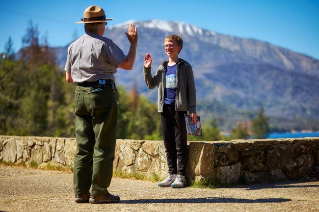 Park ranger swearing in a junior ranger at the Whiskeytown Visitor Center.