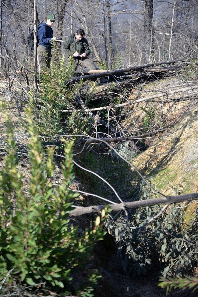 Park cultural resource specialists documenting a new water ditch in February 2020.