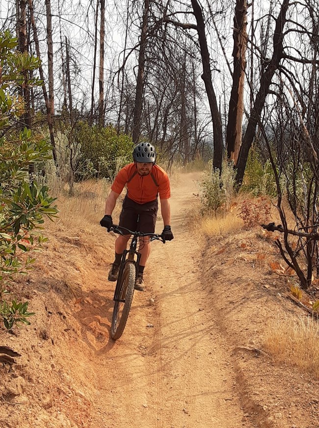 A mountain biker on his bike along Mount Shasta Mine Loop Trail.