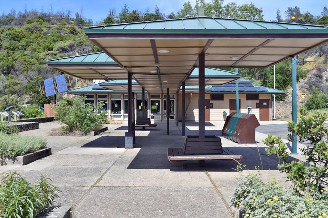 Single story building with covered walkway and mutliple windows.