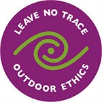 Purple circle with white letters, Leave No Trace logo