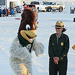 Riley the Roadrunner is dancing next to a park ranger
