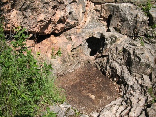 a small hole about ten inches wide in a rocky outcrop