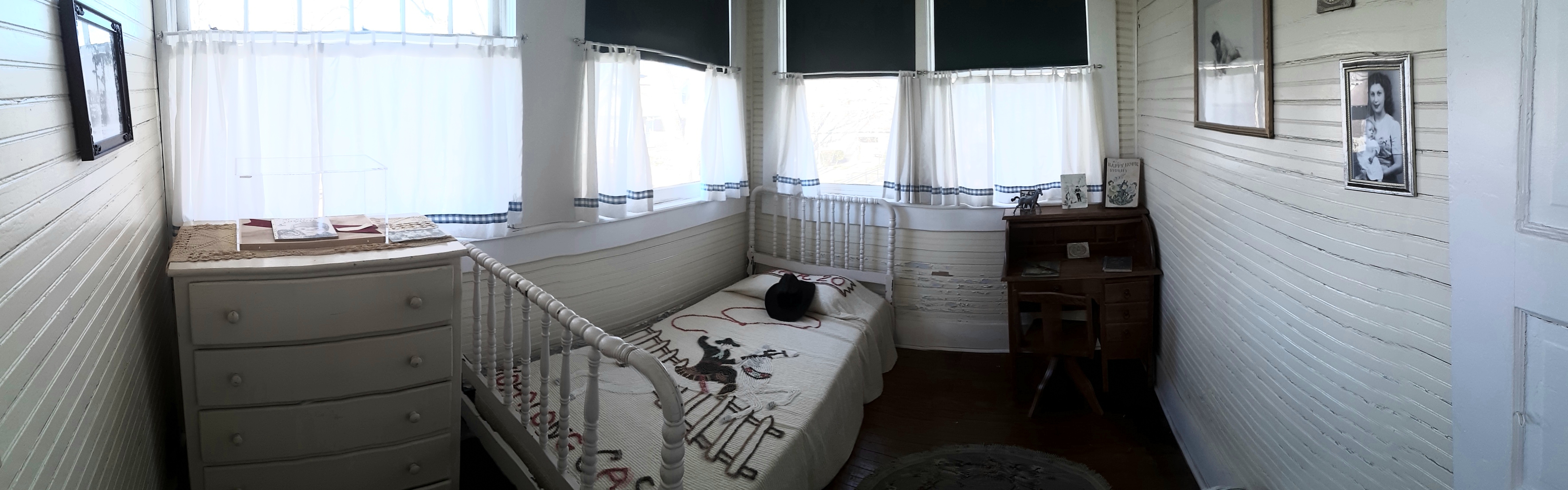 The room of young Bill Clinton with roll-top desk, dresser and bed with Hopalong Cassidy blanket.