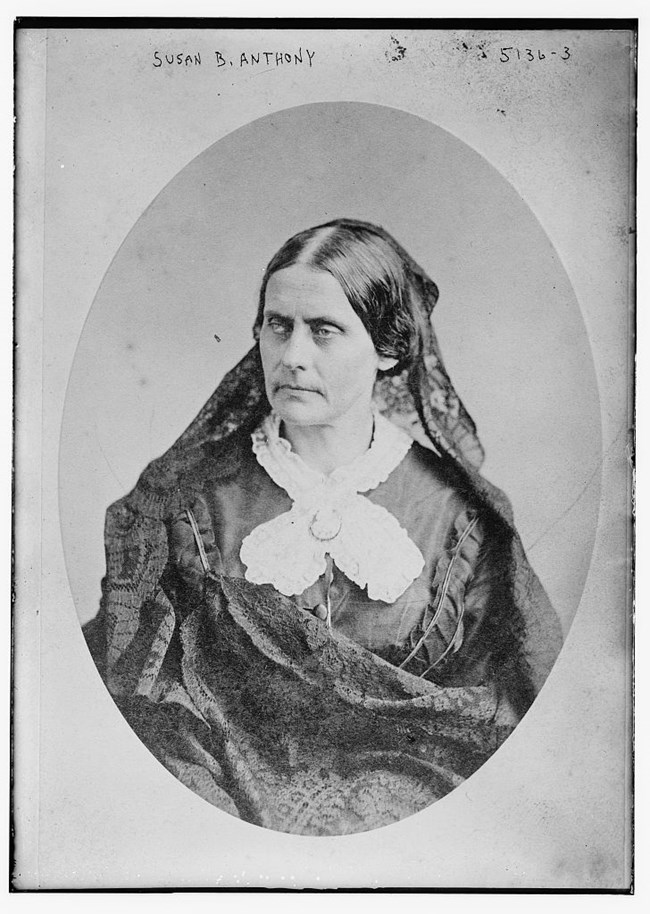 Portrait of Susan B. Anthony facing left with a black dress and black hair lace.