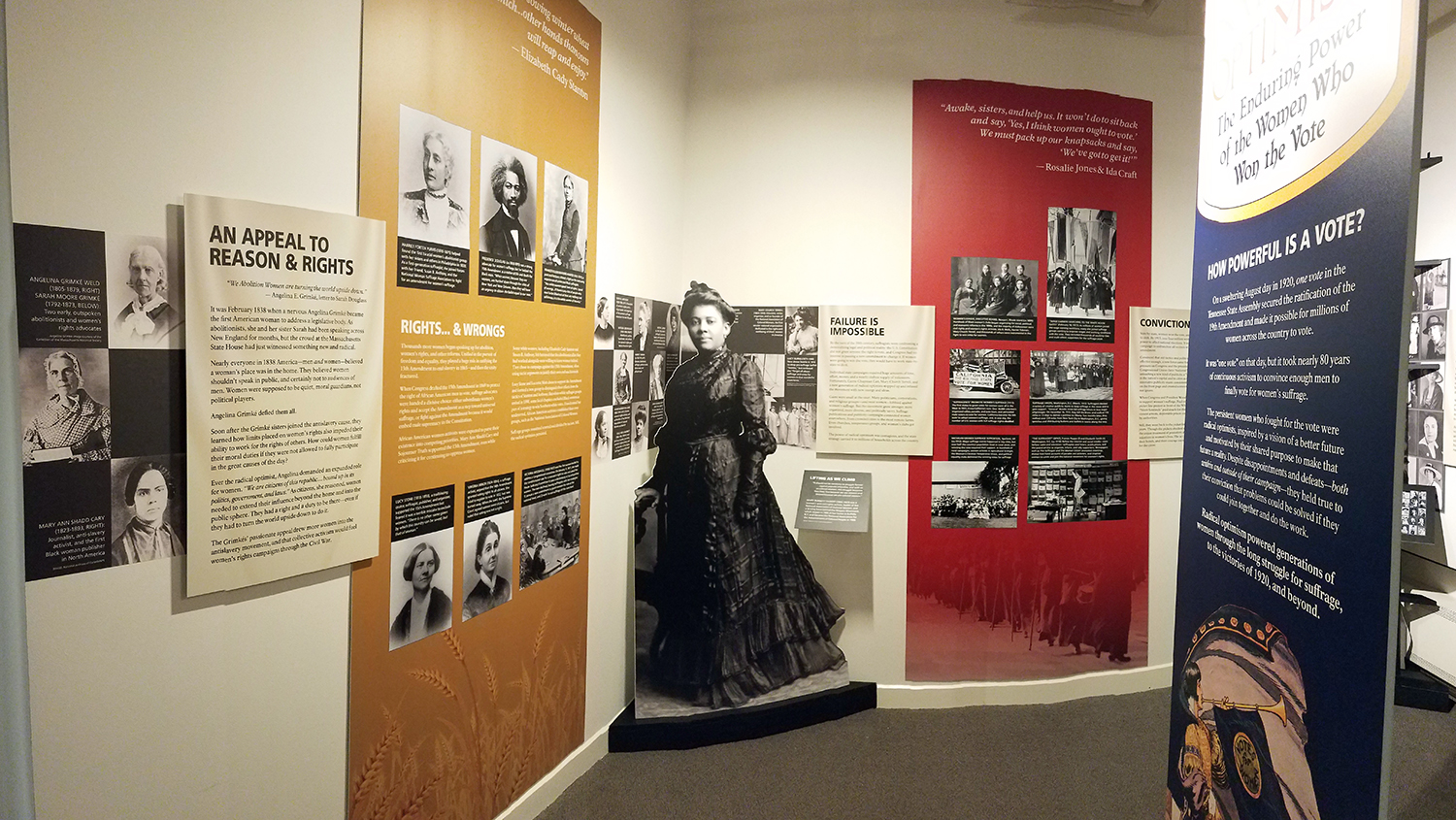 Panoramic image of entry to exhibit room. Two of the three sides of the exhibit are visible, with a portion of the entry panel on the right.