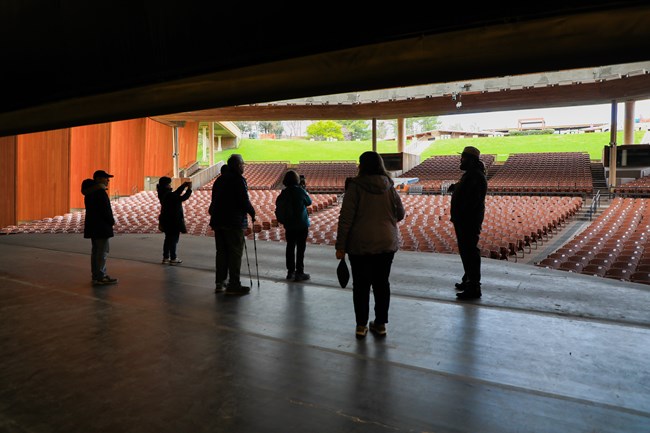 Ranger leads a tour out onto the Filene Center stage.