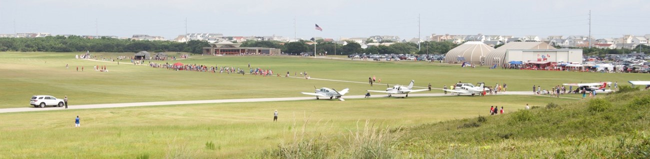 Visitors and plans of the grassy mall during National Aviation Day