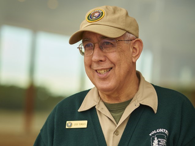 Portrait photo of an older white male dressed in park volunteer uniform