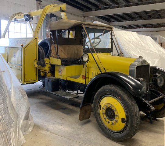 Image of a yellow wrecker vehicle in a warehouse.