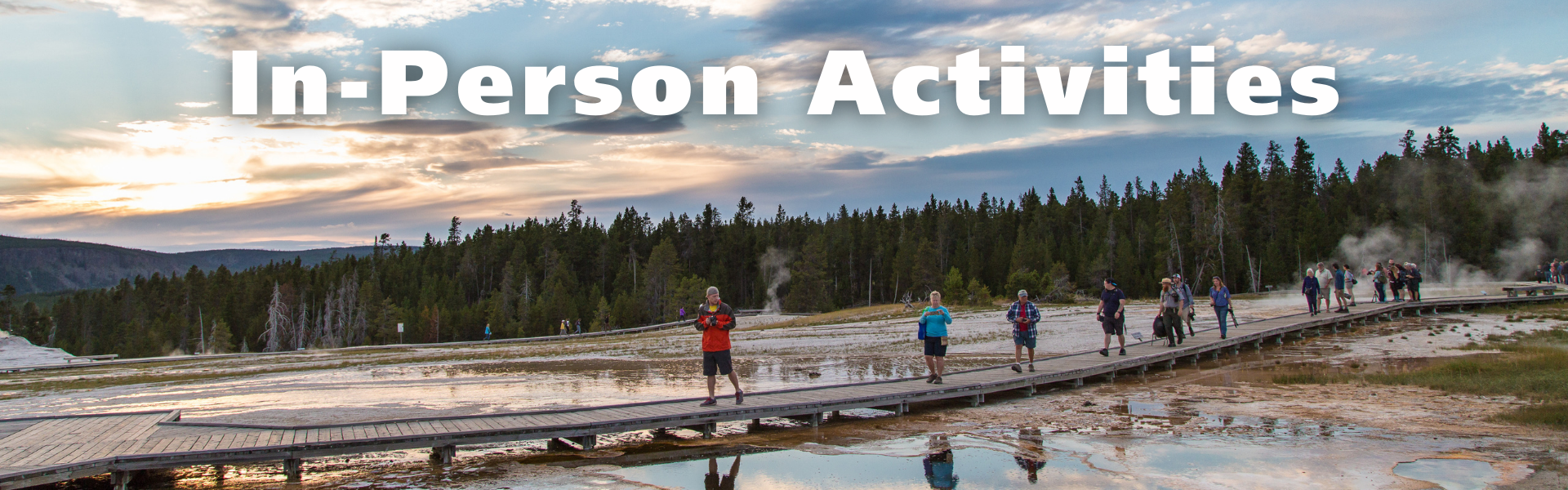 Section Header: people walking on a boardwalk above a colorful thermal feature at sunset with overlaying text, "In-Person Activities"