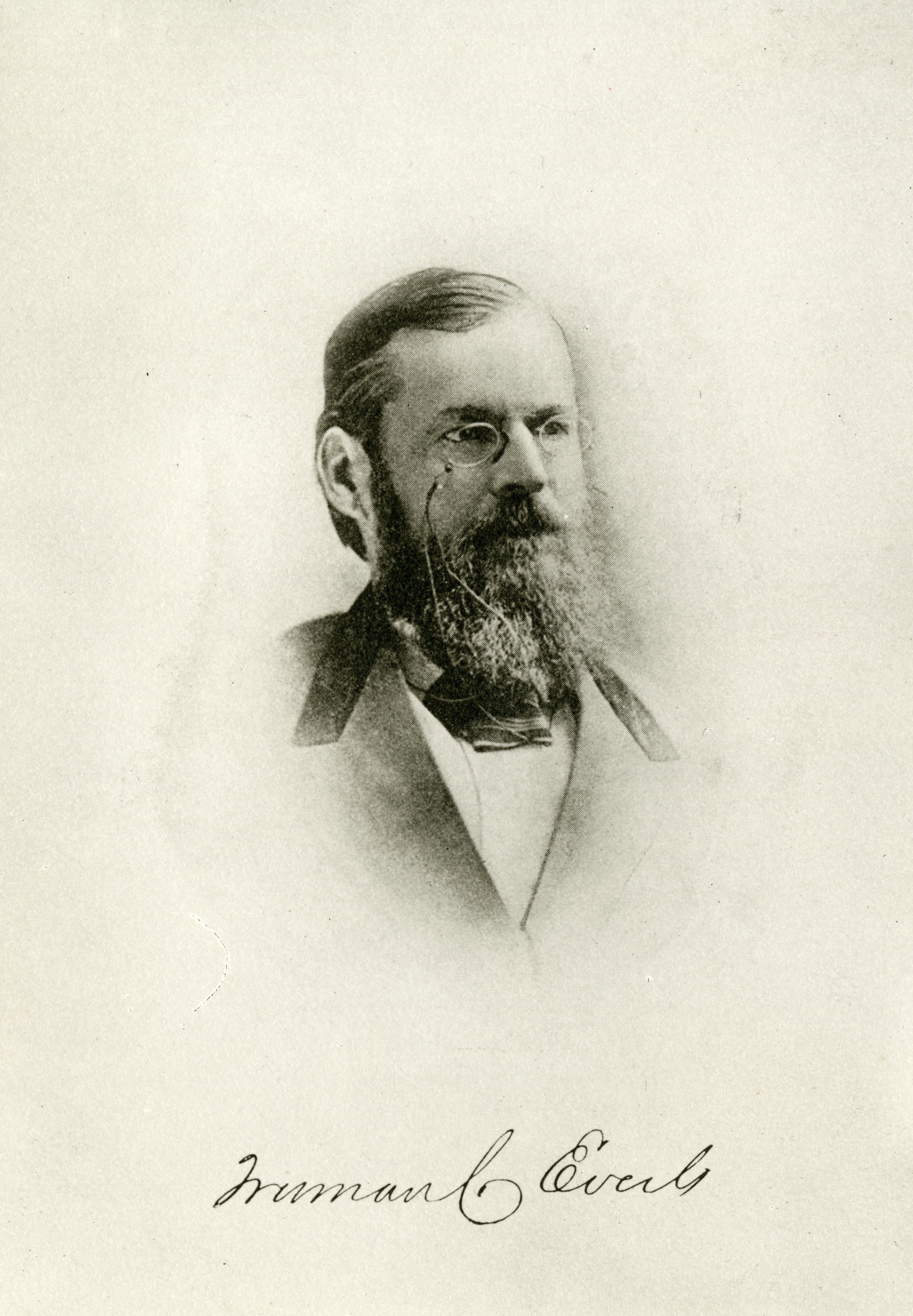 A black-and-white portrait of a man with a long brown beard and glasses