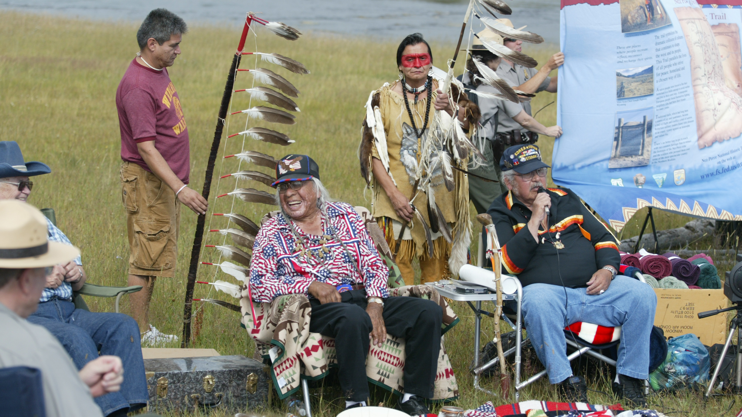 Nez Perce tribe members and NPS Rangers sit together during a commemoration of the Nez Perce Trail.