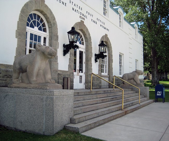 Two rock bears flank an entrance to building with several stairs