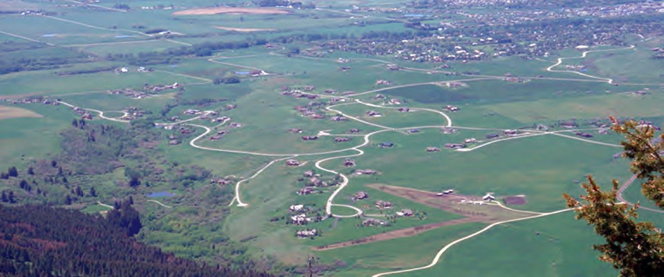 A wide view of sprawling roads intermixed with fields and natural areas