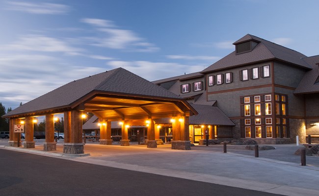 A park lodge lit up in the evening