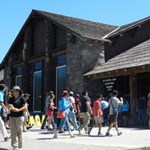 Visitors walking into the front door of Old Faithful Lodge