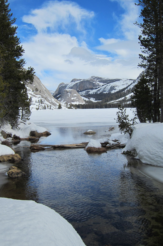 Snow-covered lake with domes in background