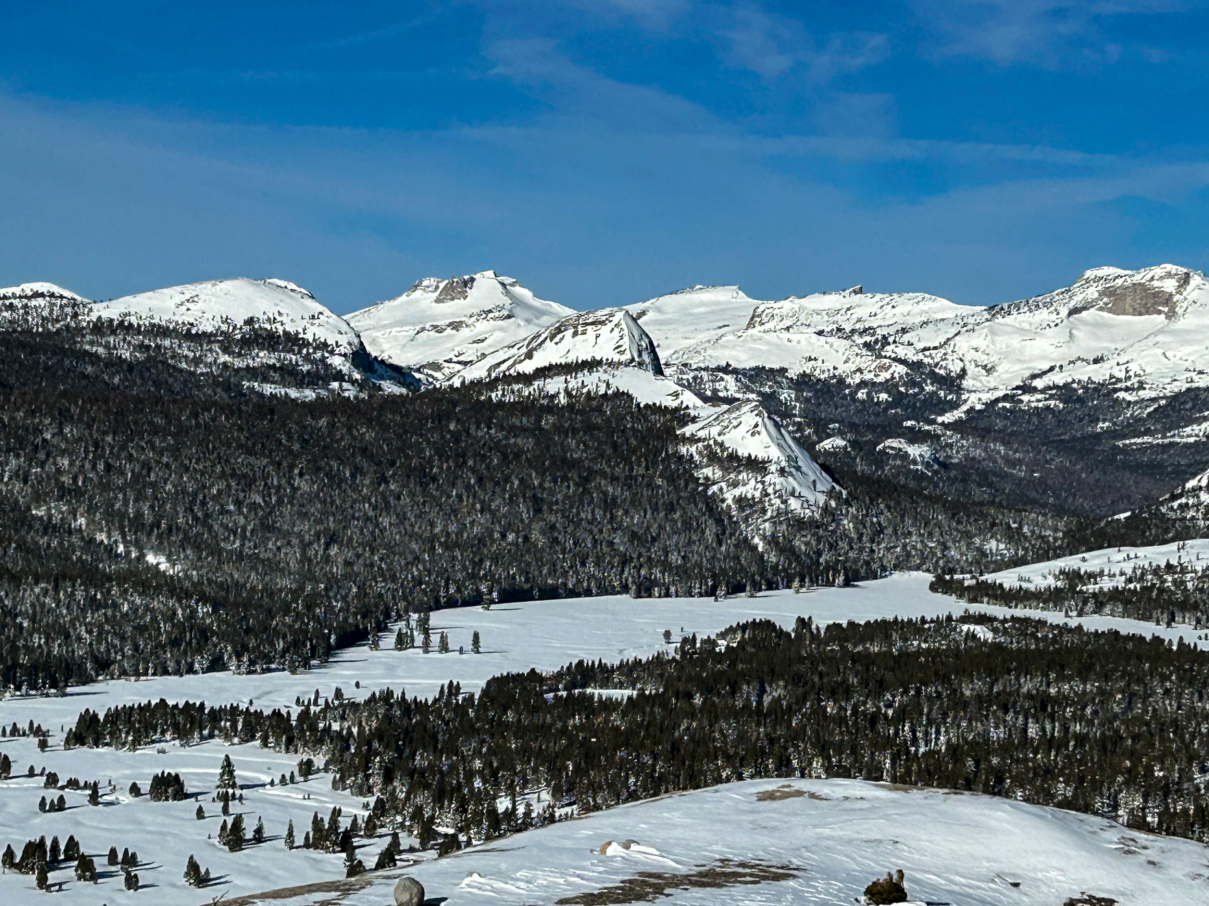 Looking down on Tuolumne Meadows and surrounding peaks, all covered in snow