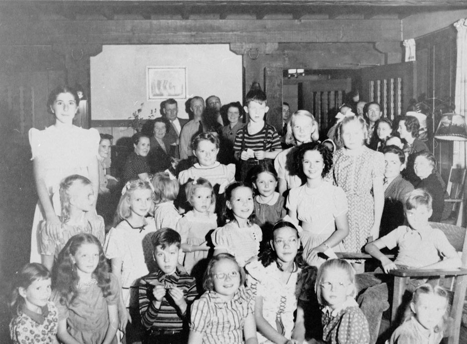 Group of about 30 white children and adults