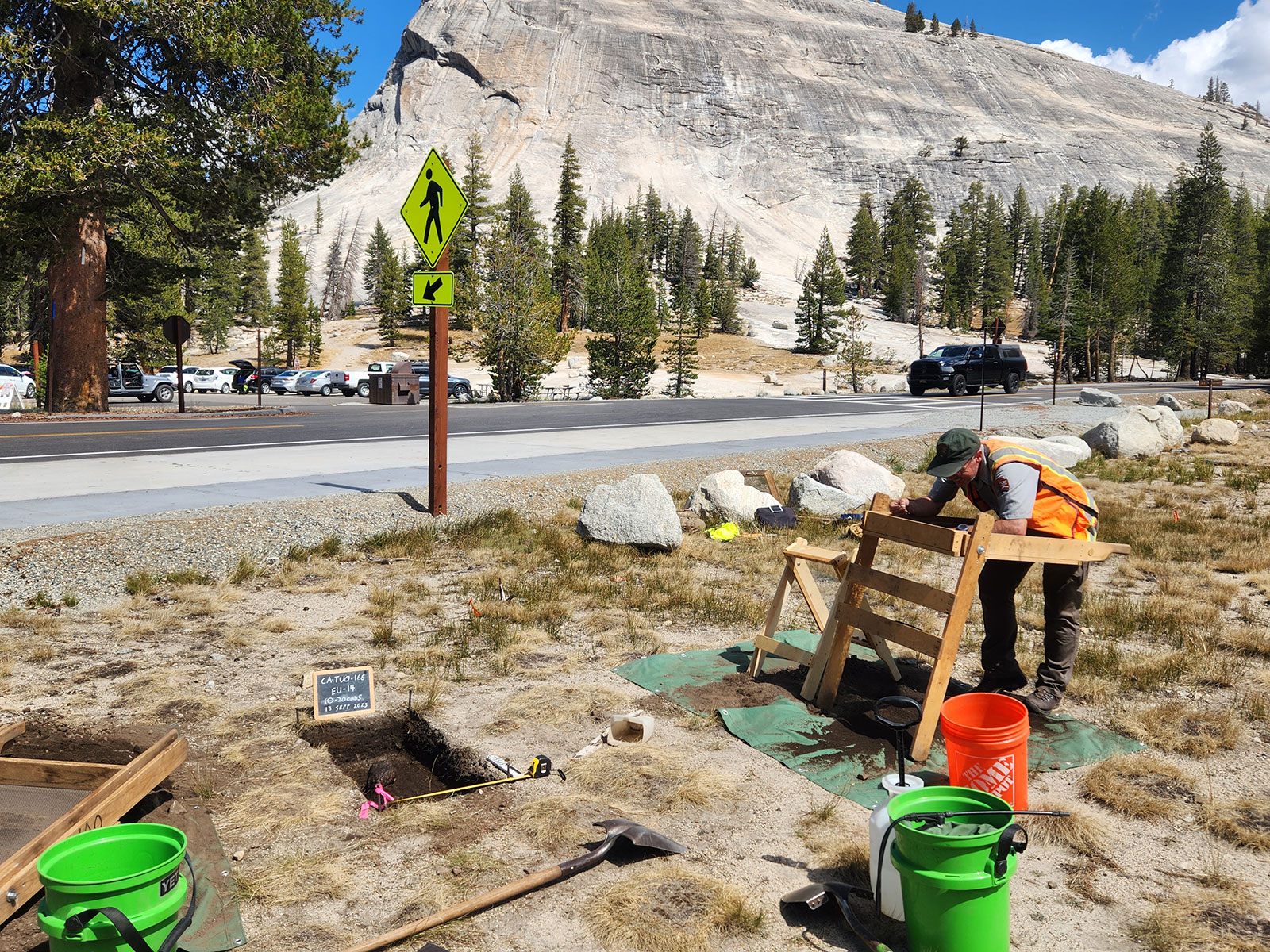 Archeologist at an excavation site near Lembert Dome in 2023.