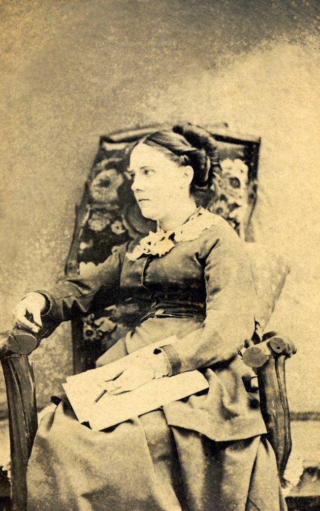 Late 19th century black and white photo of a woman sitting in a chair