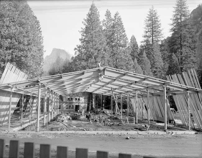 Steel framing of a building under construction with Half Dome in the background