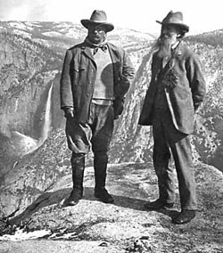 Muir and Roosevelt stand on an overhanging rock
