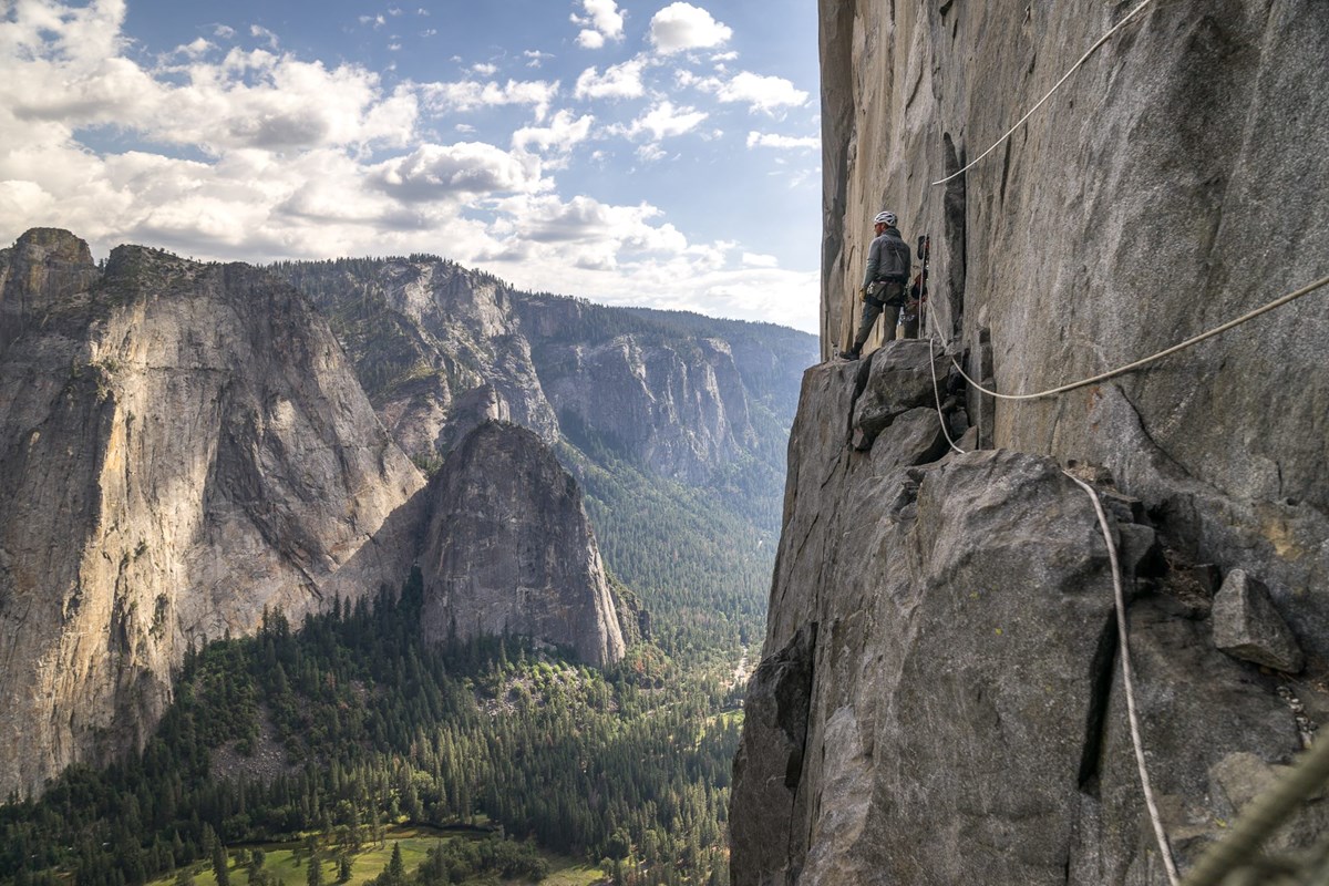 Climber and ropes looking across the Valley while on El Capitan