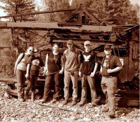 ASRA archaeology students standing in front of historic mining equipment