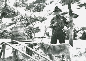 Arthur 'Cap' Reynolds with a dog at Sam Creek Cabin