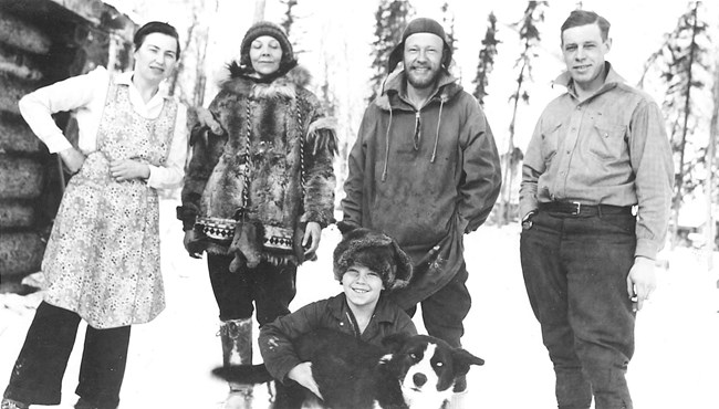 Mildred and Al Hendricks Jr with sled dog Taku and friends