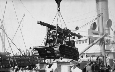 "The Prospecter" drill rig begin unloaded from a steamship, 1934.