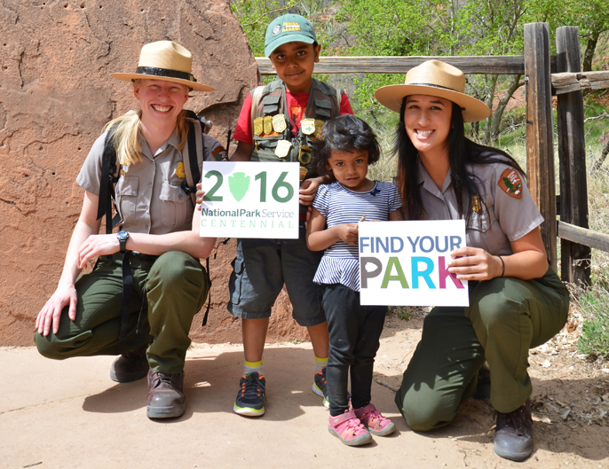 Park rangers and Junior Rangers smiling.