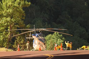 A helicopter on the ground with a SAR team working nearby.